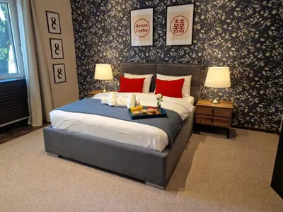 a bedroom with a large bed with red pillows at Family & Friends Apt, Skadarlija in Belgrade