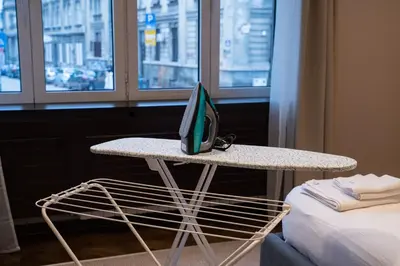 a television sitting on a table next to a bed at Family & Friends Apt, Skadarlija in Belgrade
