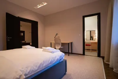 a bedroom with a bed and a desk and a table at Family & Friends Apt, Skadarlija in Belgrade