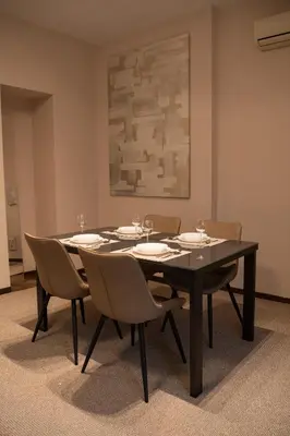 a dining room with a black table and chairs at Family & Friends Apt, Skadarlija in Belgrade