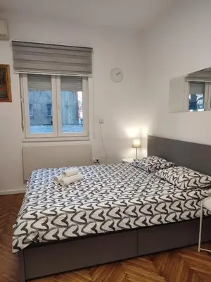 a large bed in a room with a window at Belgrade apartment Bulevar II in Belgrade