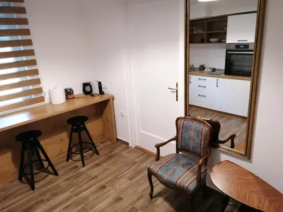 a room with a mirror and a table and chairs at Belgrade apartment Bulevar II in Belgrade