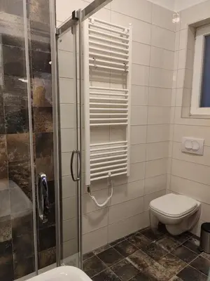 a bathroom with a toilet and a glass shower at Belgrade apartment Bulevar II in Belgrade