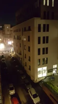 a view of a parking lot with cars parked in front of a building at Idealna lokacija. in Sajmište