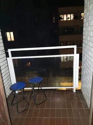 two blue chairs on a balcony with a window at Idealna lokacija. in Sajmište