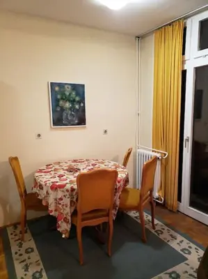 a dining room table with a table and two chairs at Idealna lokacija. in Sajmište