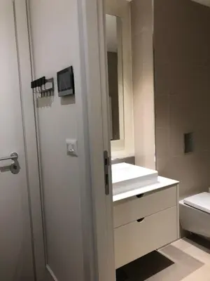 a bathroom with a white sink and a mirror at Lovely BW Metropolitan studio in Belgrade