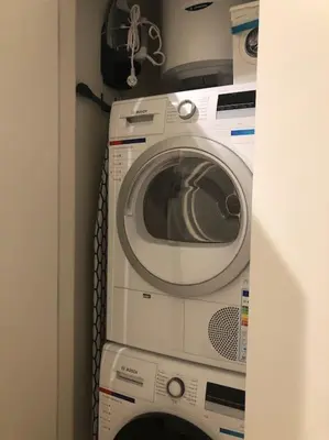 a washing machine and a dryer in a room at Lovely BW Metropolitan studio in Belgrade