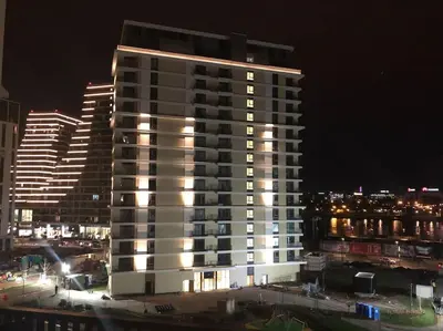 a tall building with lights on in a city at night at Lovely BW Metropolitan studio in Belgrade