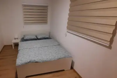 a small bedroom with a bed and a staircase at Old Cherry Apartment in Vračar (historical)