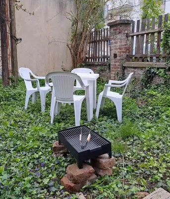 a group of white chairs and a table and a grill at Old Cherry Apartment in Vračar (historical)