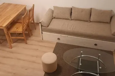 a living room with a couch and a table at Old Cherry Apartment in Vračar (historical)