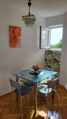 a dining room with a glass table and chairs at GREY apartment in Belgrade