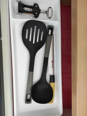 a plastic utensil in a white container with a spatula at GREY apartment in Belgrade