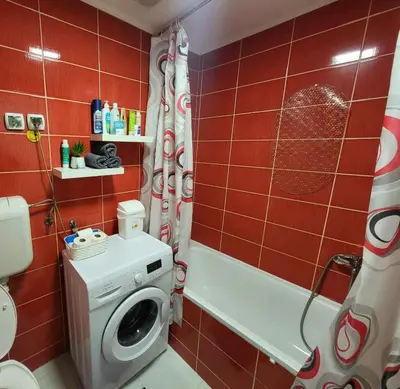 a bathroom with a washing machine and a shower at GREY apartment in Belgrade