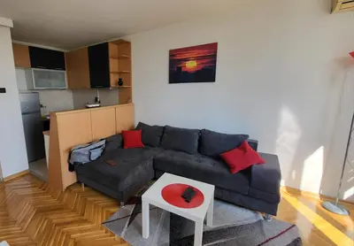 a living room with a couch and a table at GREY apartment in Belgrade