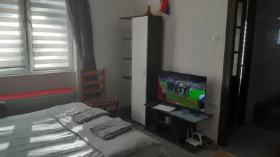 a bedroom with a bed and a flat screen tv at Despot in Belgrade