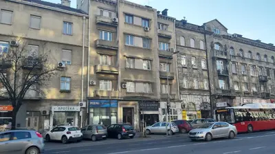 a city street with cars parked in front of buildings at Despot in Belgrade