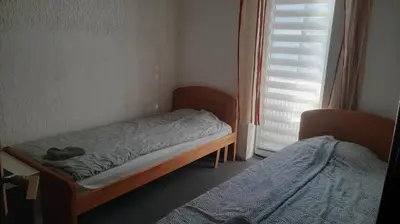 a small bedroom with a bed and a window at Despot in Belgrade