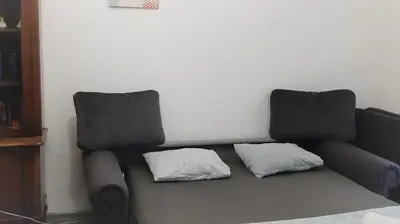 a couch with two pillows sitting in a living room at Despot in Belgrade