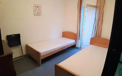 a small room with two beds and a window at Despot in Belgrade