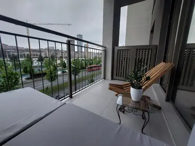 a balcony with a bench and a view of a city at PARK APARTMENTS Belgrade Waterfront in Sajmište