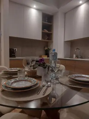 a dining room table with plates and wine glasses at PARK APARTMENTS Belgrade Waterfront in Sajmište