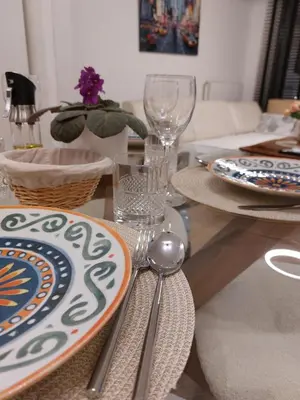 a dining room table with plates and utensils on it at PARK APARTMENTS Belgrade Waterfront in Sajmište