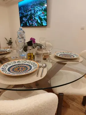 a dining room table with plates and glasses on it at PARK APARTMENTS Belgrade Waterfront in Sajmište