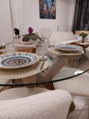 a living room with a glass table with plates on it at PARK APARTMENTS Belgrade Waterfront in Sajmište