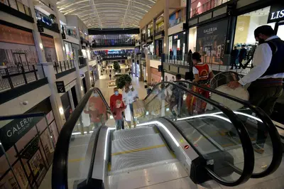 an escalator in a shopping mall with people on it at PARK APARTMENTS Belgrade Waterfront in Sajmište