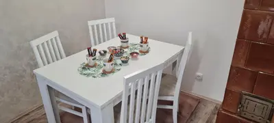 a white table with chairs and candlesticks on it at JULIJA apartment in Belgrade