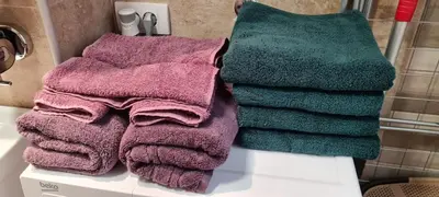 a pile of towels sitting on a counter in a bathroom at JULIJA apartment in Belgrade