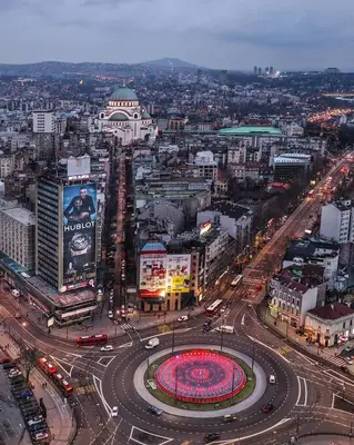 a city with a busy street with cars and buildings at JULIJA apartment in Belgrade
