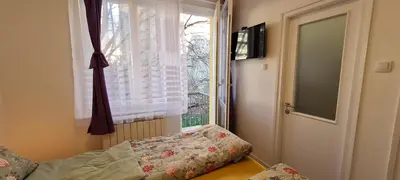 a bedroom with a window and a bed with a pillow at JULIJA apartment in Belgrade