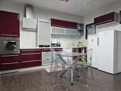 a kitchen with a glass table and white appliances at Vila Odiseas in Belgrade