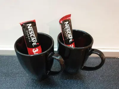 two black cups with candy in them on a counter at Altina Connect - all new, parking, Netflix in Belgrade