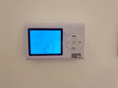 a remote control is attached to a wall at Altina Connect - all new, parking, Netflix in Belgrade