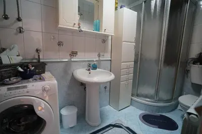 a bathroom with a washing machine and a sink at Rajana , Beograd - Hram Svetog Save in Vračar (historical)