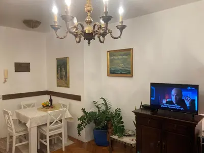 a living room with a chandelier and a tv at Rajana , Beograd - Hram Svetog Save in Vračar (historical)