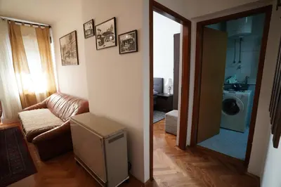 a living room with a box on the floor and a mirror at Rajana , Beograd - Hram Svetog Save in Vračar (historical)