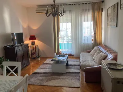a living room with a couch and a tv at Rajana , Beograd - Hram Svetog Save in Vračar (historical)