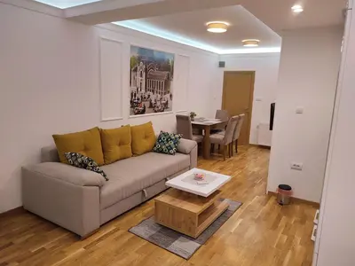 a living room with a couch and a table at TiD Apartman LUX in Arandjelovac