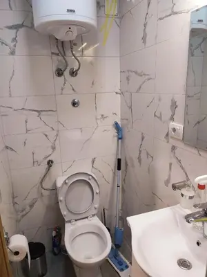 a bathroom with a toilet and a sink at TiD Apartman LUX in Arandjelovac