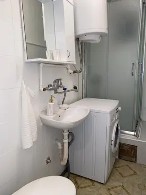 a bathroom with a sink and a toilet and a mirror at Apartman Espo in Vračar (historical)