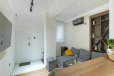 a living room with a couch and a table at Apartment Paradise Resavska in Belgrade