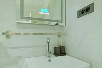 a bathroom with a sink and a mirror at Apartment Paradise Resavska in Belgrade