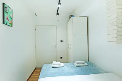 a bedroom with two beds and a mirror at Apartment Paradise Resavska in Belgrade