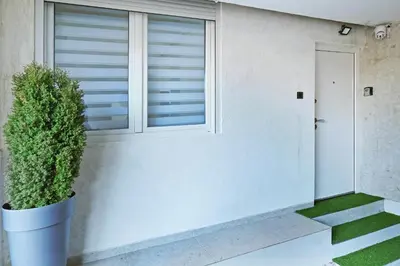 a house with a plant in a pot next to a window at Apartment Paradise Resavska in Belgrade