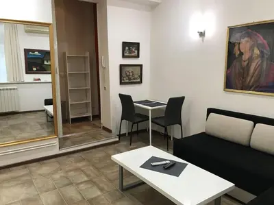 a living room with a couch and a table at Saint Sava studio in Belgrade